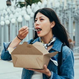 portrait asian exchange student enjoying baked potato los angeles county museum art blurred background installation art urban light