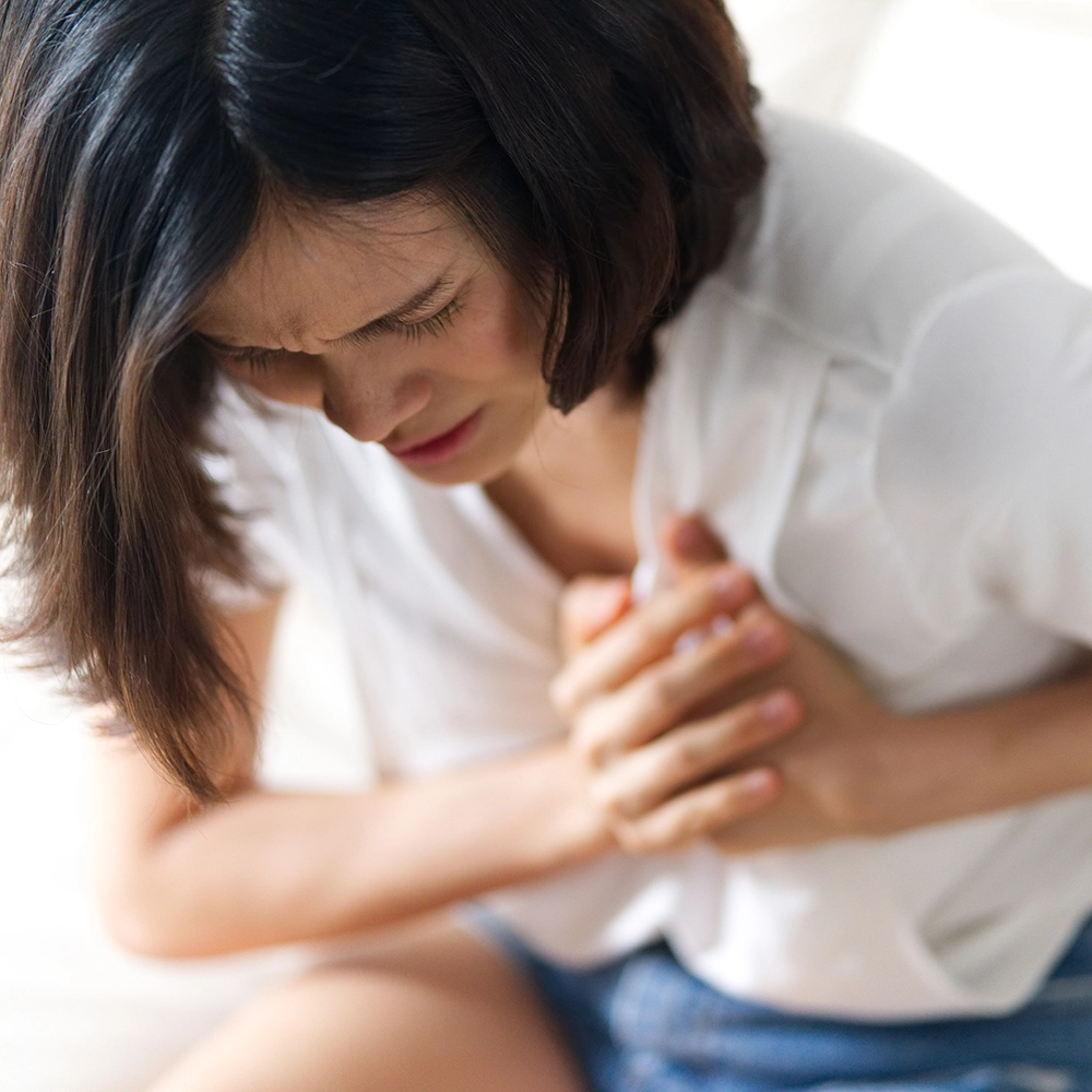 asian woman having heart attack sitting on sofa 2021 11 12 23 10 51 utc