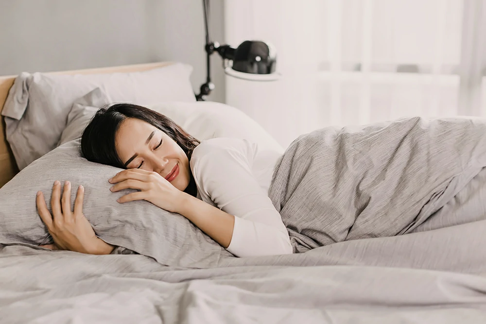 happy asian woman is resting gentle pillow bed