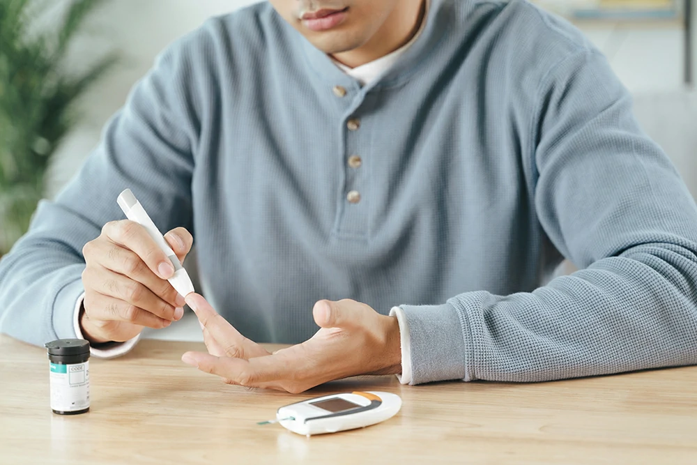 man using lancet finger checking blood sugar level by glucose meter diabetes concept